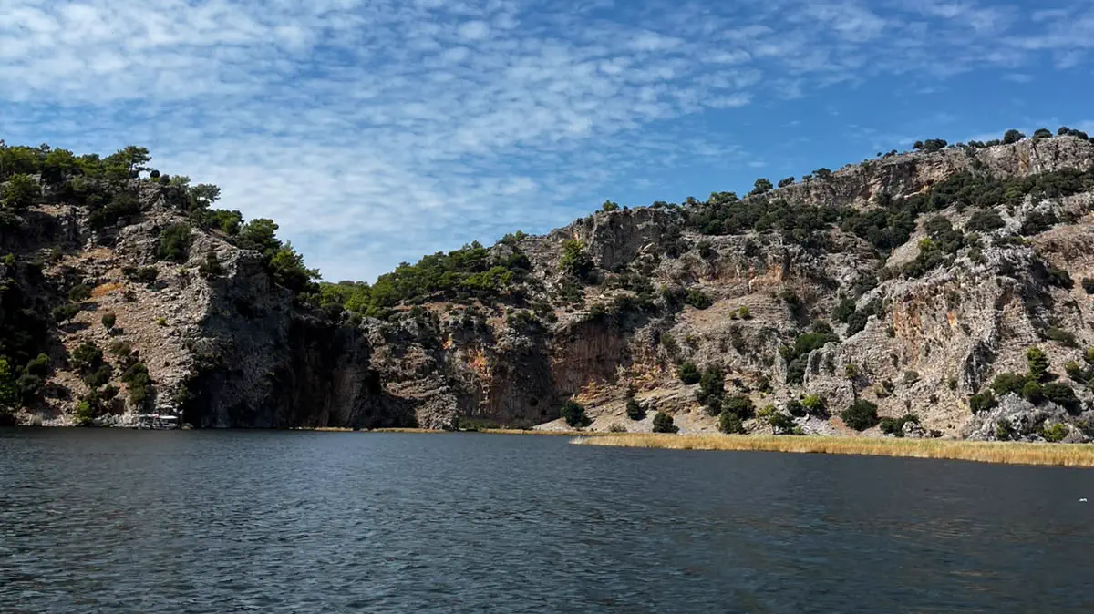 The Dalyan river running below the limestone ridge, reed beds on both banks The Dalyan river running below the limestone ridge, reed beds on both banks