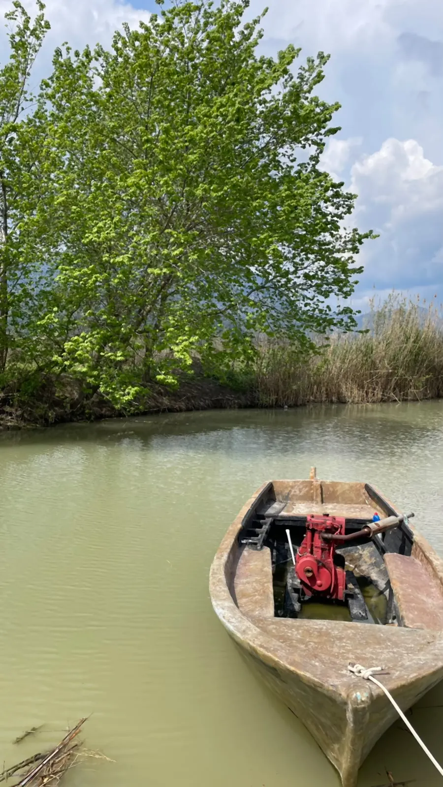A working boat on the channel under spring clouds