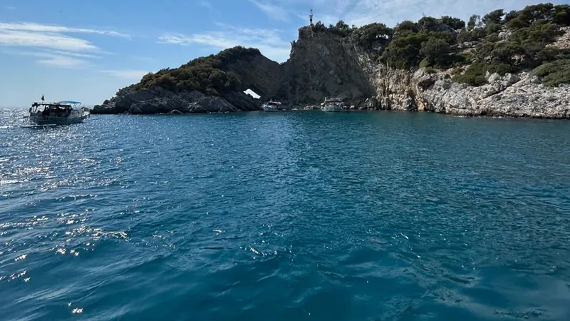 Boats anchored off a rocky headland near Dalyan