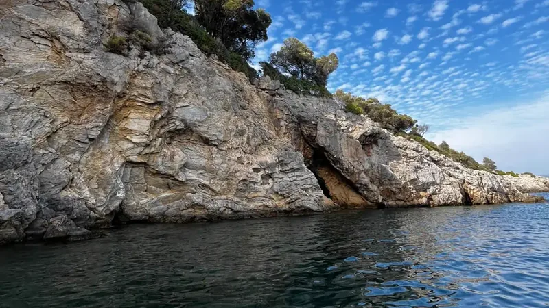 A cave mouth in the rocky coast near Dalyan A cave mouth in the rocky coast near Dalyan