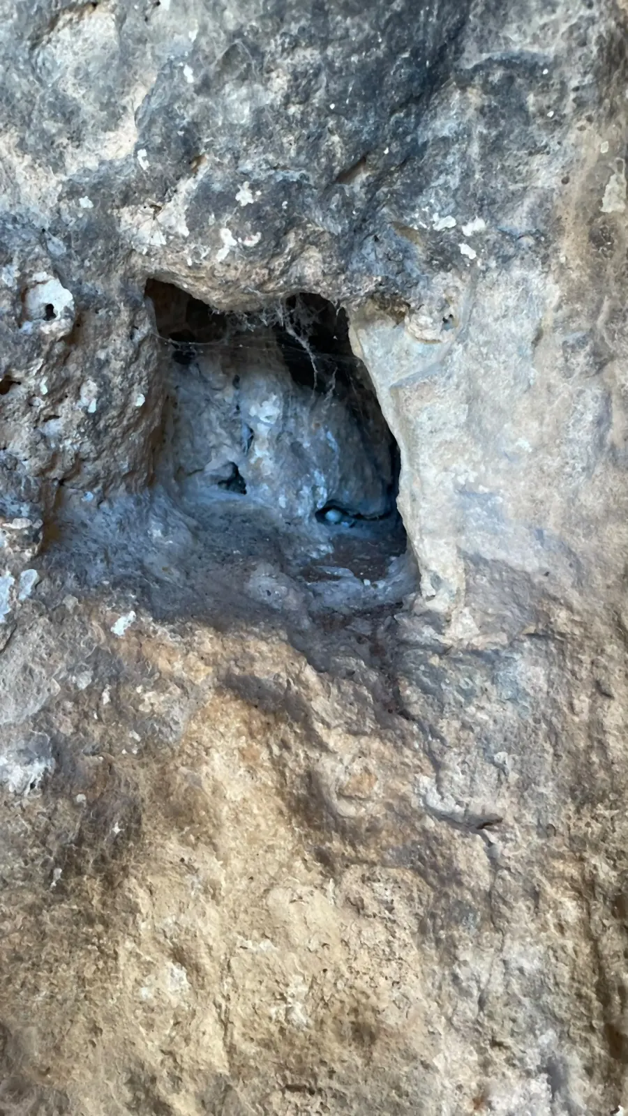 A small chamber cut into the rock face, seen close up A small chamber cut into the rock face, seen close up