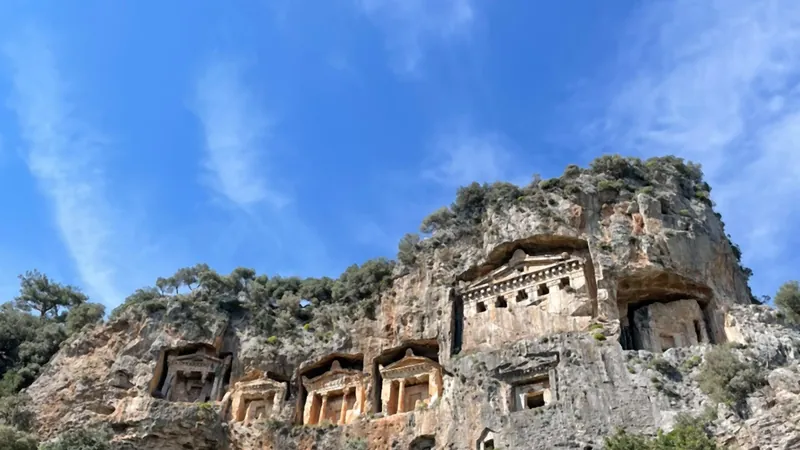 The temple fronts of the Kaunos tombs seen from the path directly below The temple fronts of the Kaunos tombs seen from the path directly below
